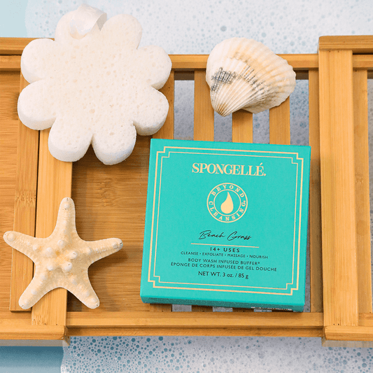 a wooden tray with a blue box and shells on it