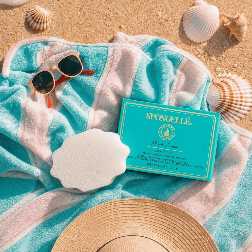 a towel and sunglasses on sand