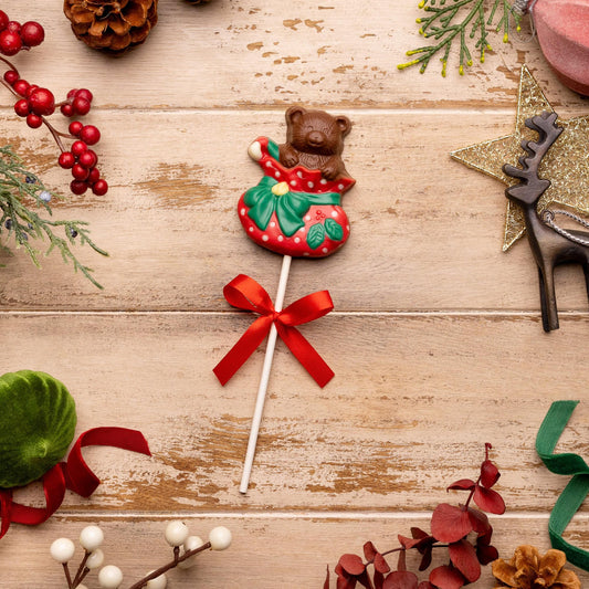 a candy on a stick surrounded by decorations