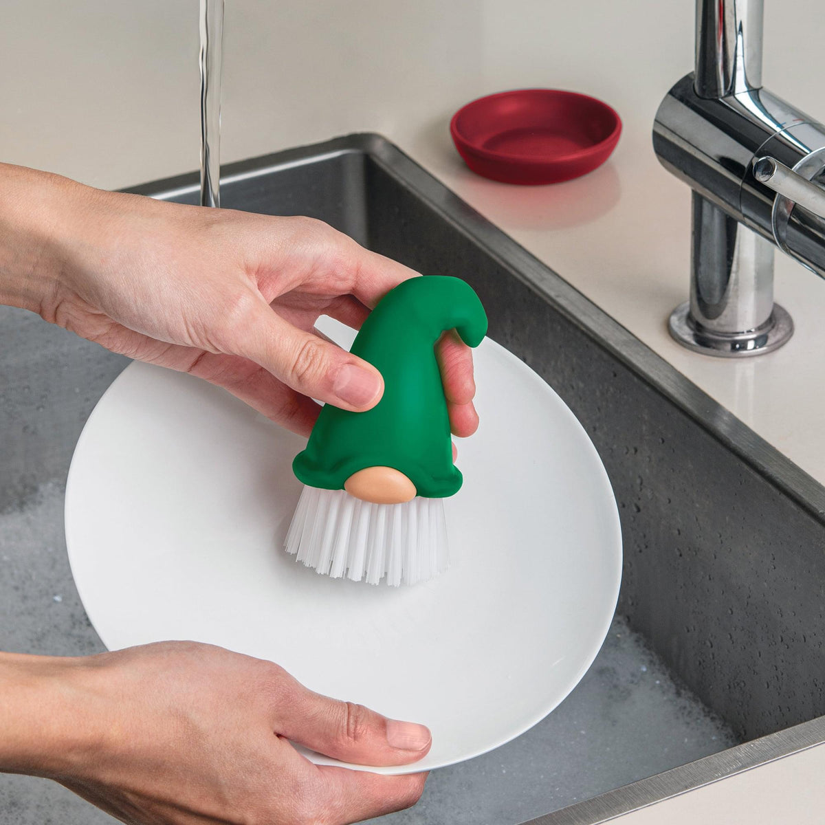 a person washing a plate