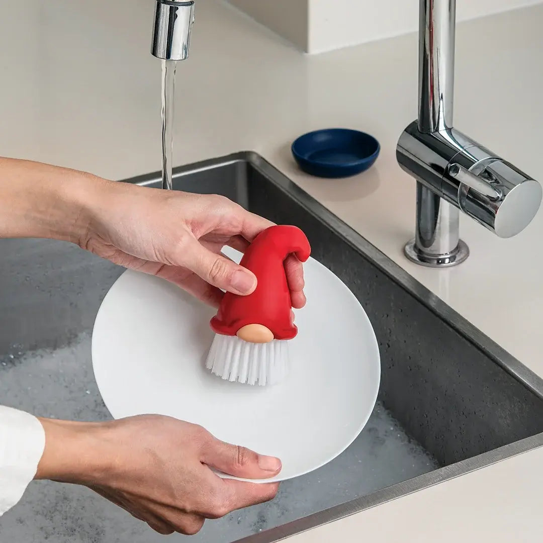 a person washing dishes in a sink