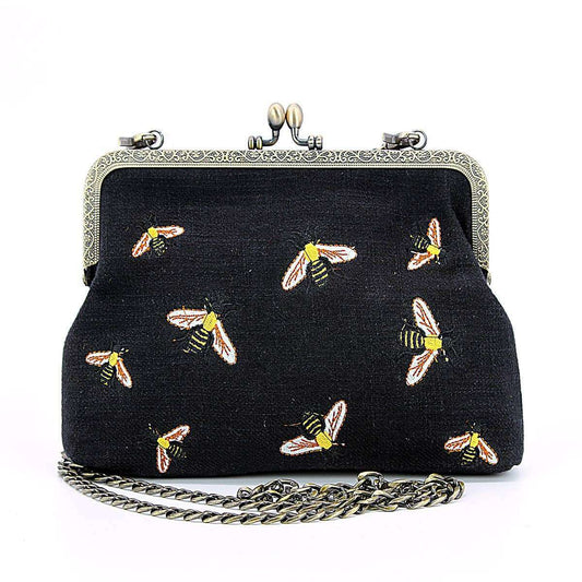 a black purse with bees on it