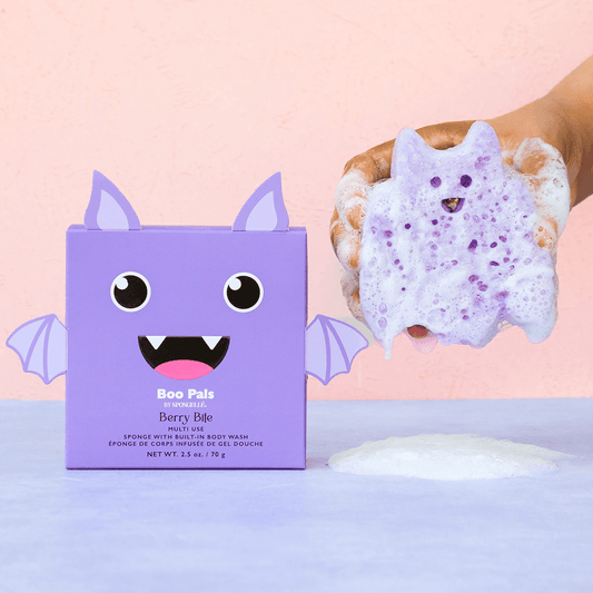 a hand holding a purple sponge over a purple box