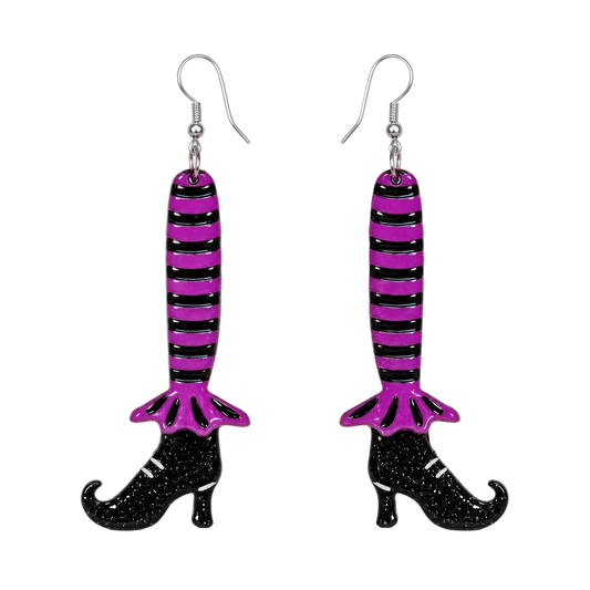 a pair of earrings with a person's leg