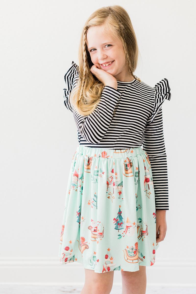 a girl smiling with her hand on her face