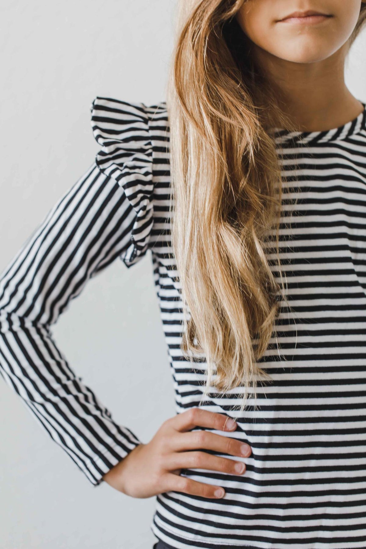 a woman with long hair in a striped shirt