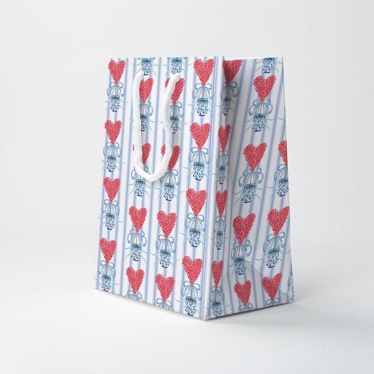a white and blue bag with red hearts on it