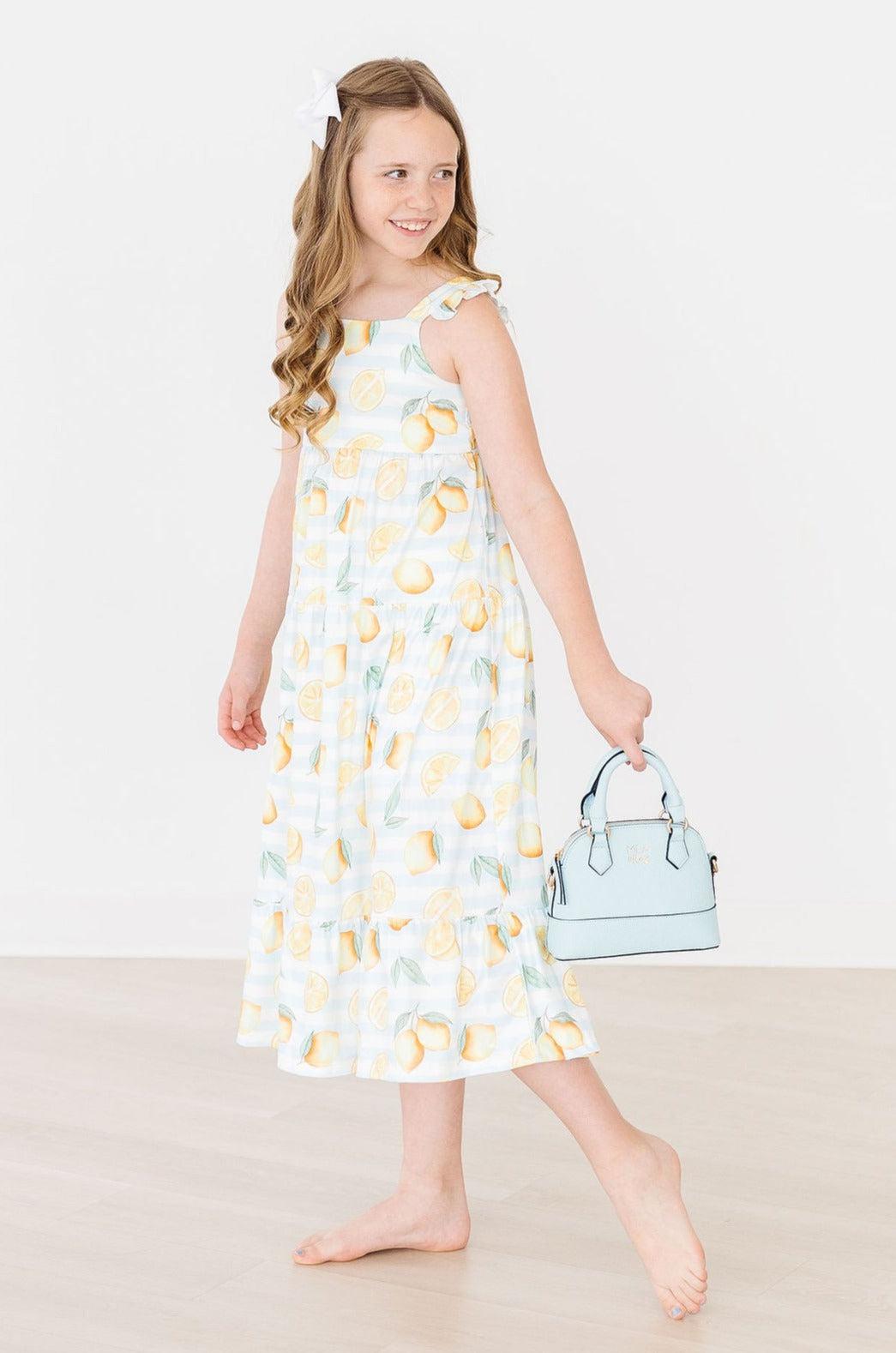a girl in a dress holding a purse