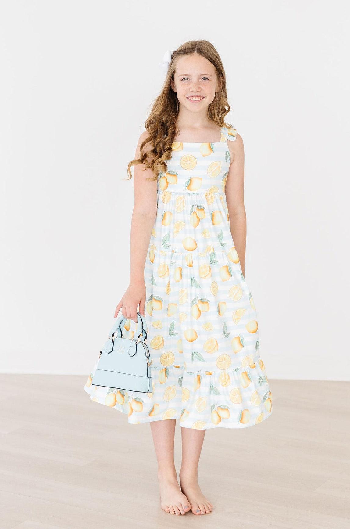 a girl in a dress holding a purse