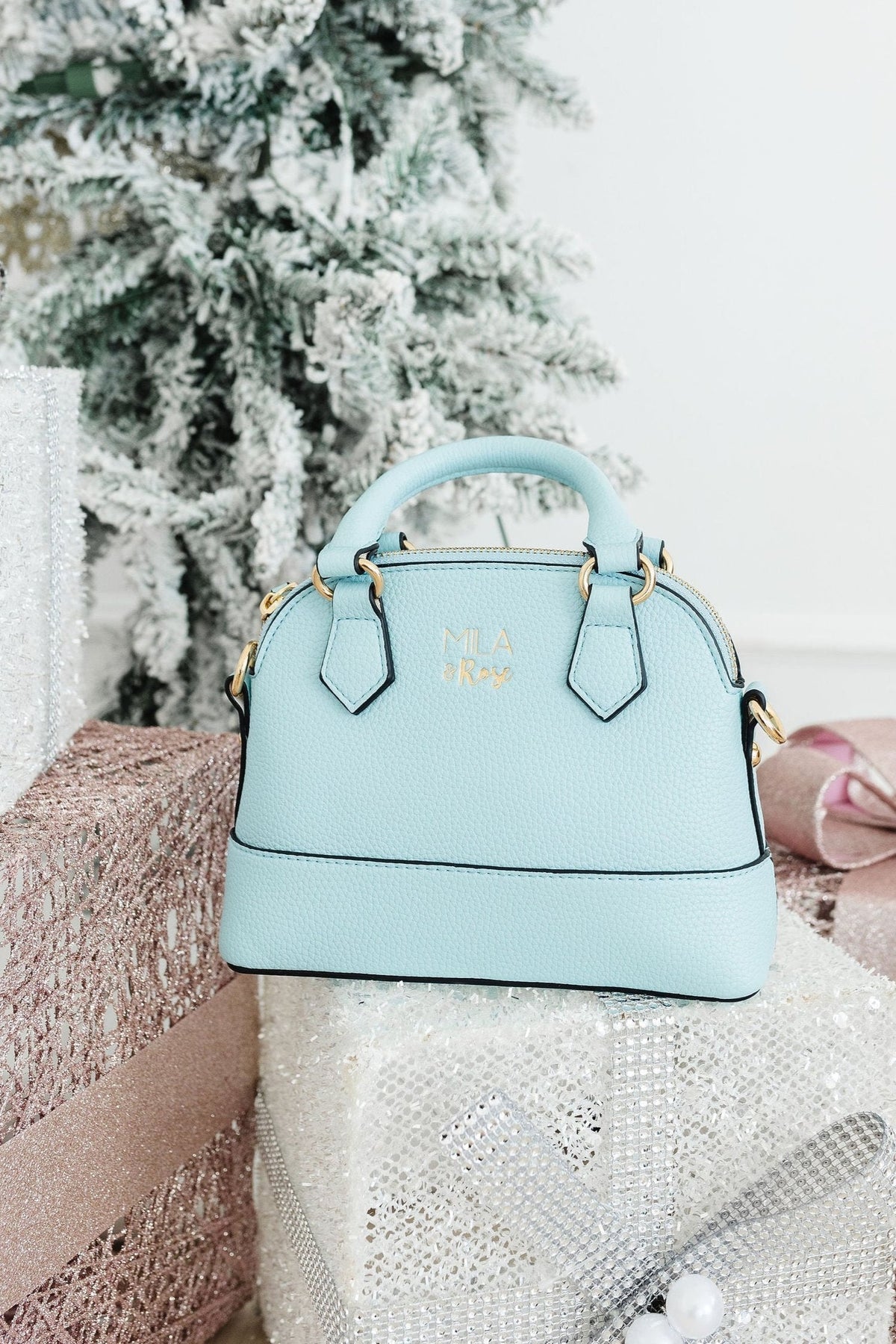 a blue handbag on a gift box