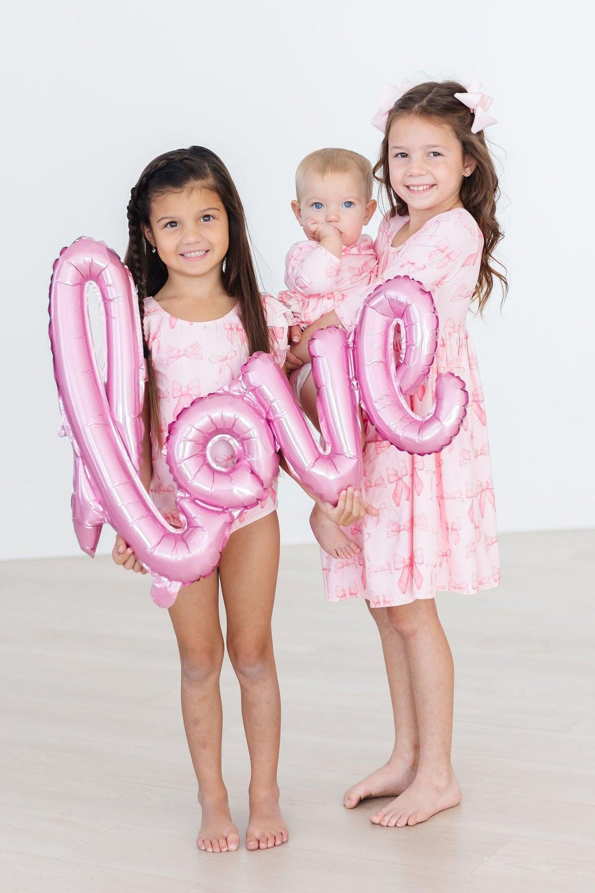 a group of girls holding a balloon
