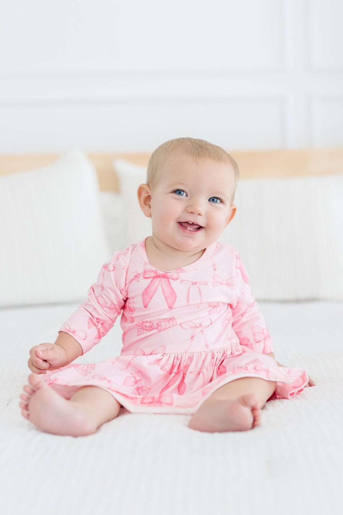 a baby sitting on a bed
