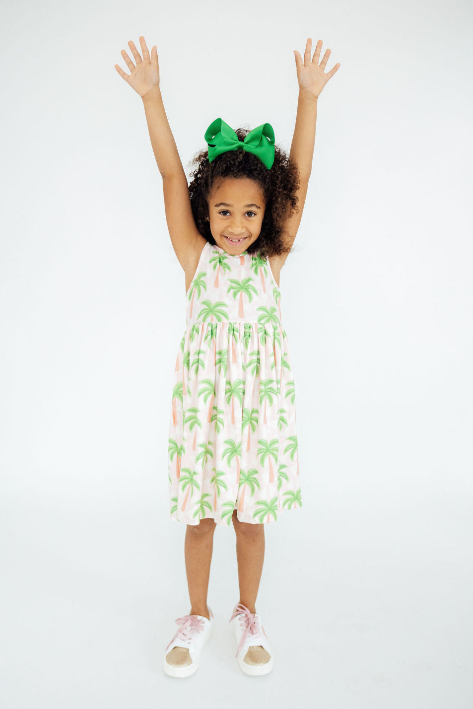 a girl with green bow and palm trees dress