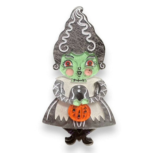 a green and black person with a pumpkin