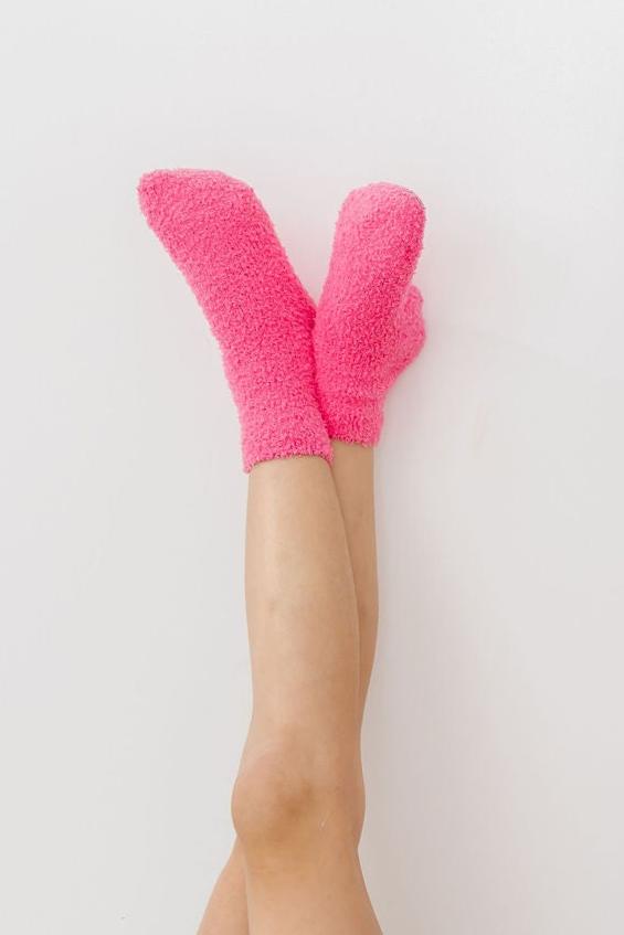 a person's legs with pink socks