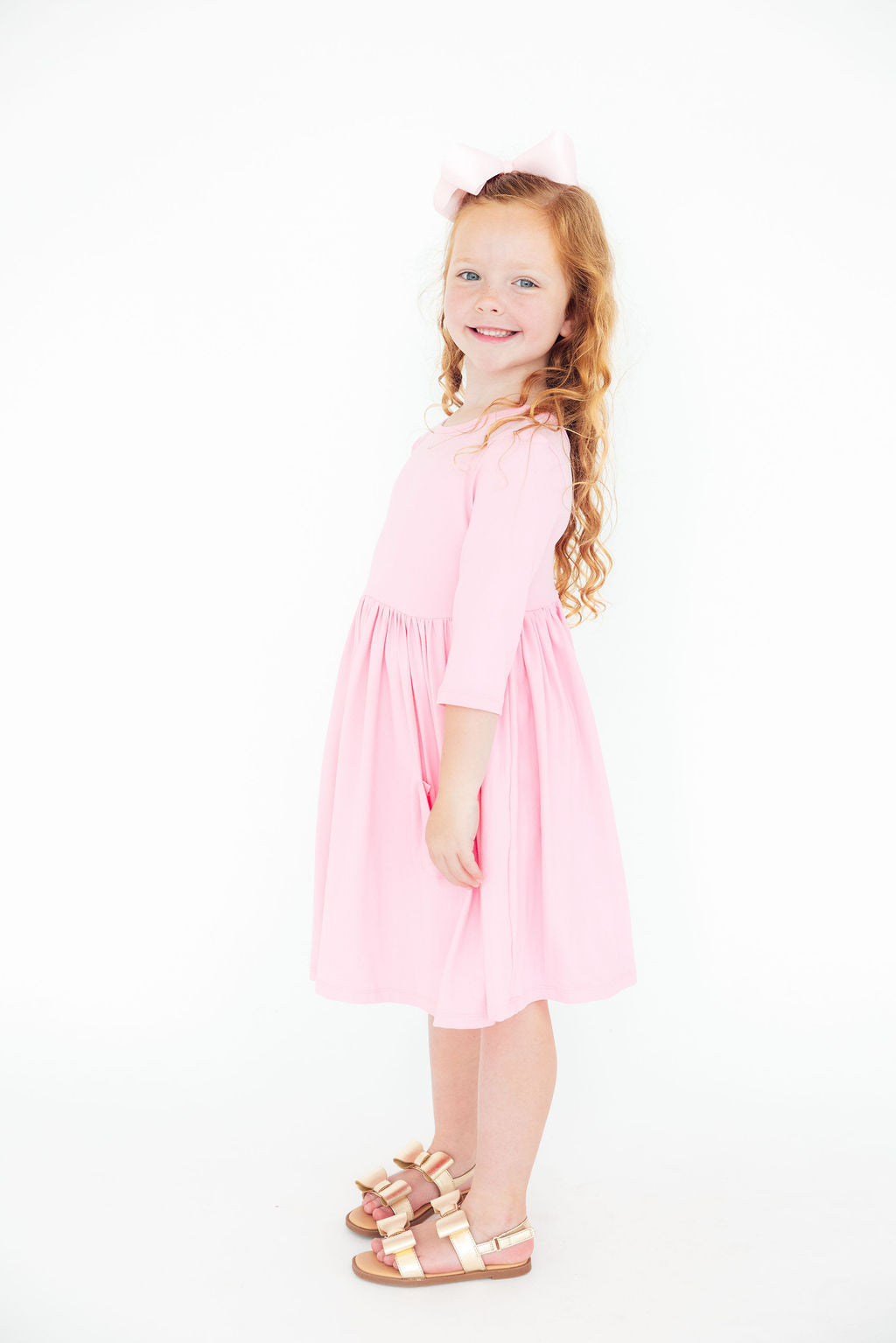 a girl in a pink dress