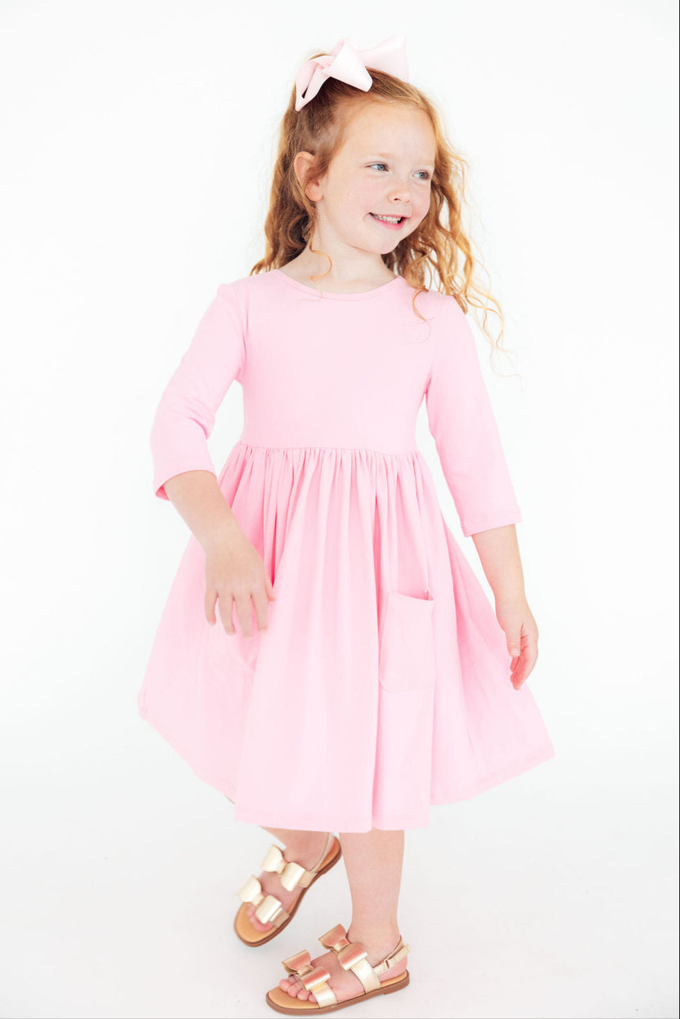 a girl in a pink dress