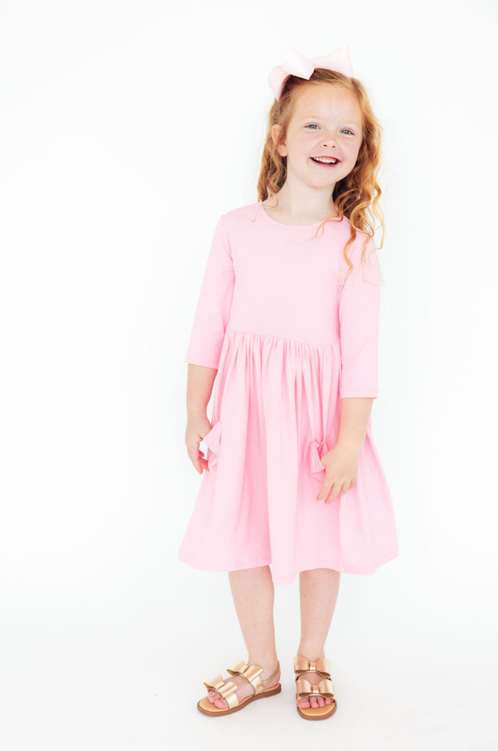 a girl in a pink dress