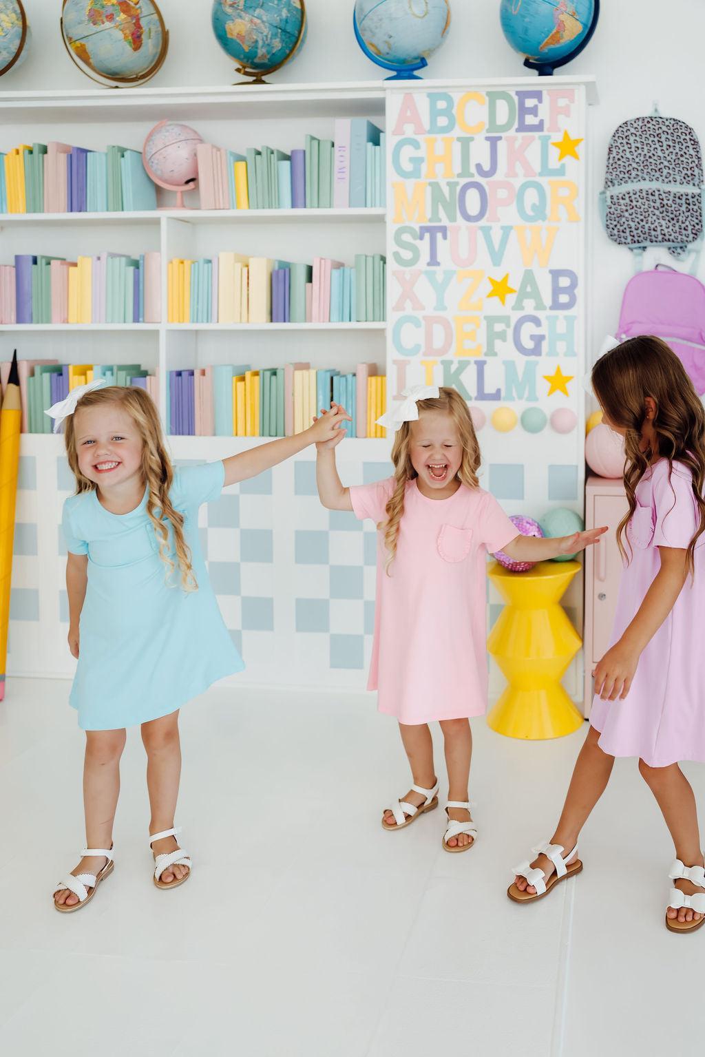 a group of girls in dresses
