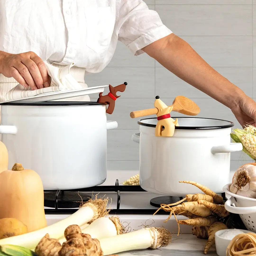 a person in a white shirt cooking in a kitchen