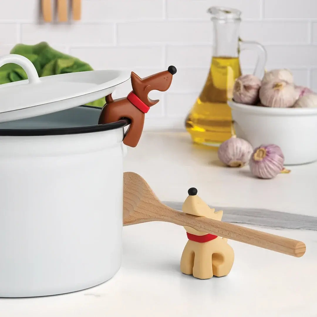 a wooden spoon and a pot with a dog shaped object