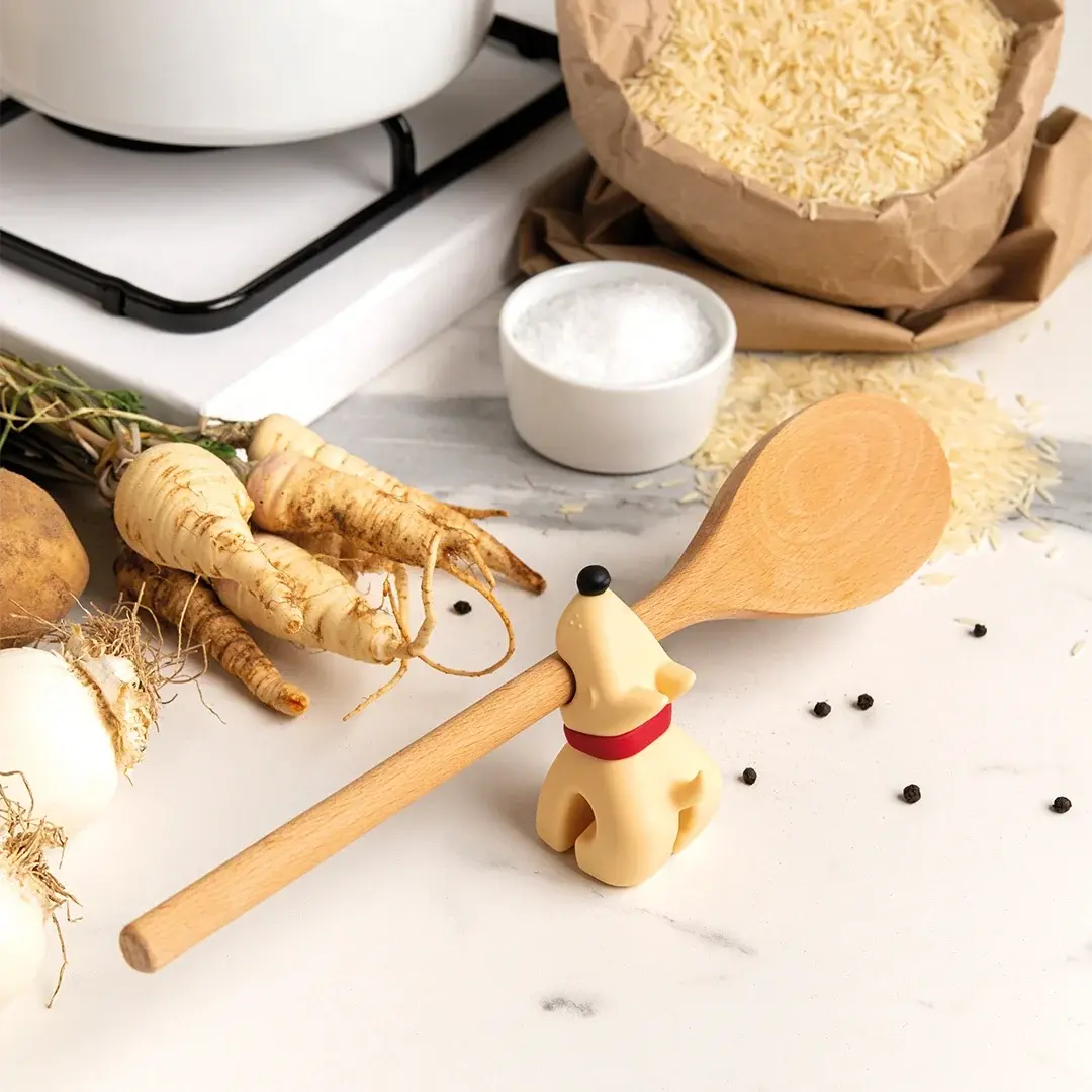 a wooden spoon in a dog shape with a wooden handle