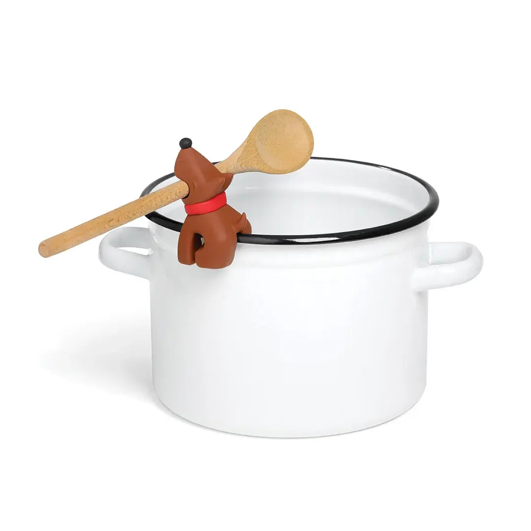 a white pot with a wooden spoon in it
