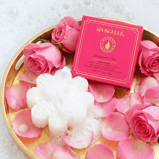 a pink rose petals and a sponge in a gold bowl