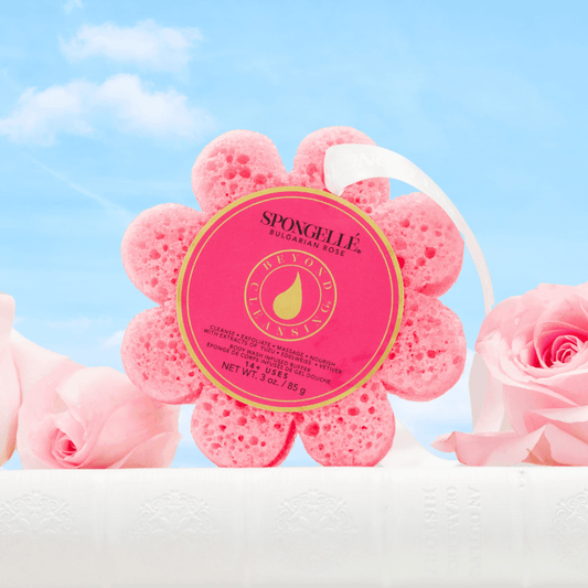 a pink sponge in a flower shape next to pink roses