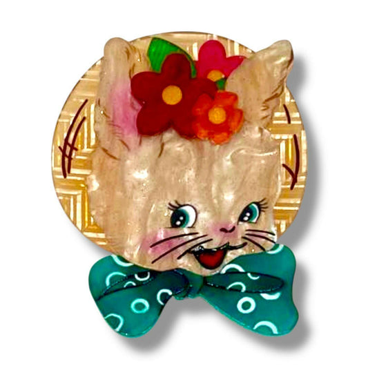 a cat with flowers on a plate