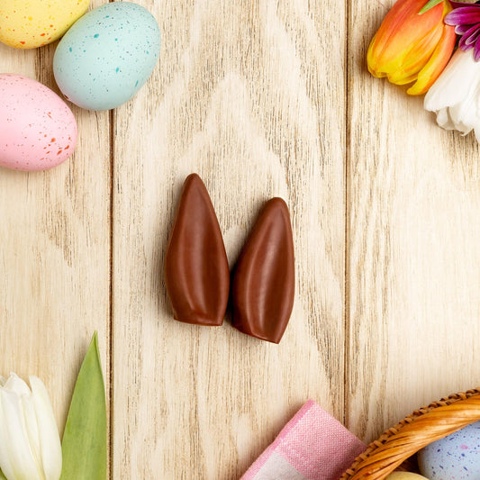 a basket of flowers and chocolate eggs