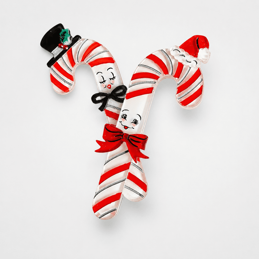 a candy canes with faces and a hat