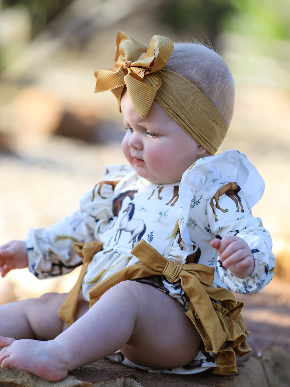 a baby wearing a dress and bow