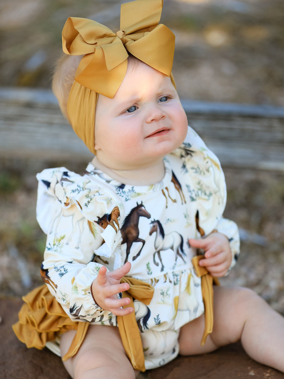 a baby wearing a yellow bow