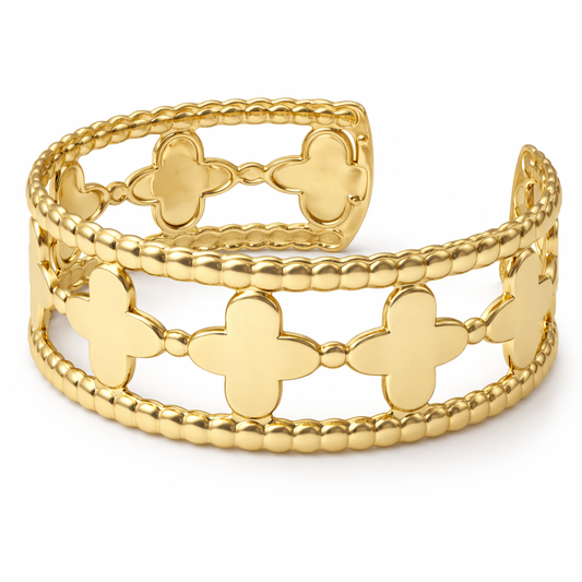 a gold bracelet with crosses on it