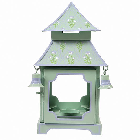 a small green and purple object with bells