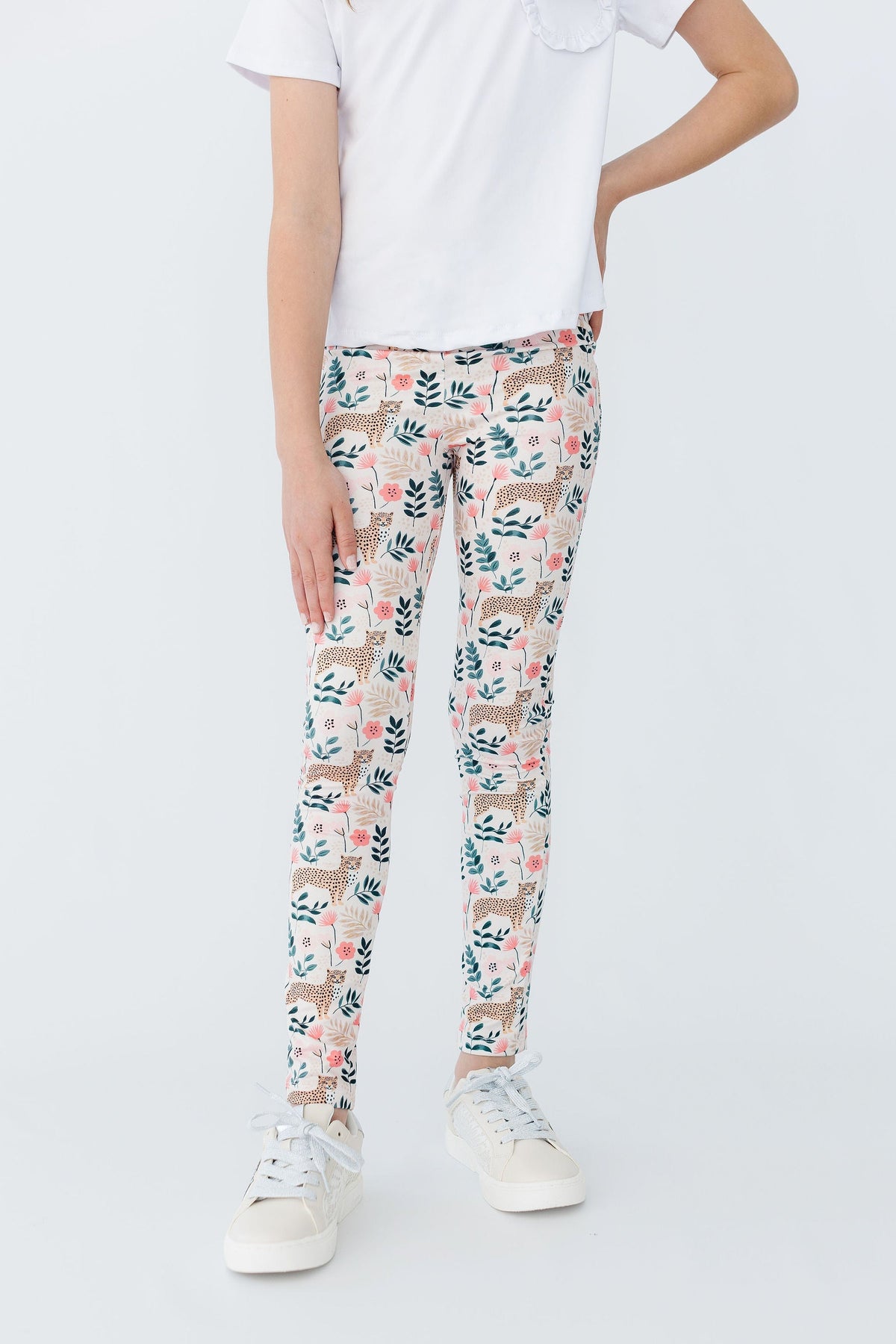 a person wearing white pants with a floral pattern