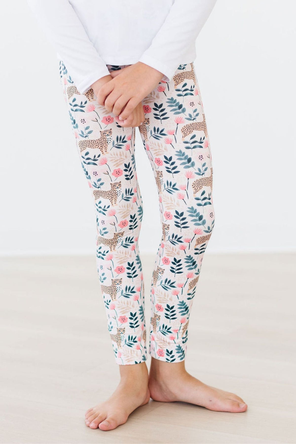 a person wearing white pants with floral print