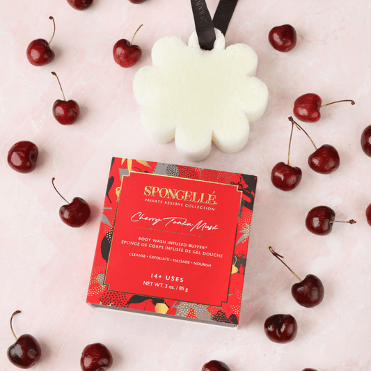 a small box with a white object next to a red box with cherries