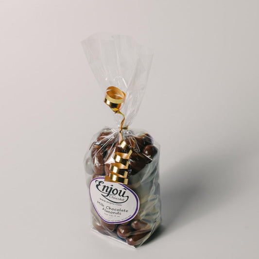 a bag of chocolates with a gold ribbon