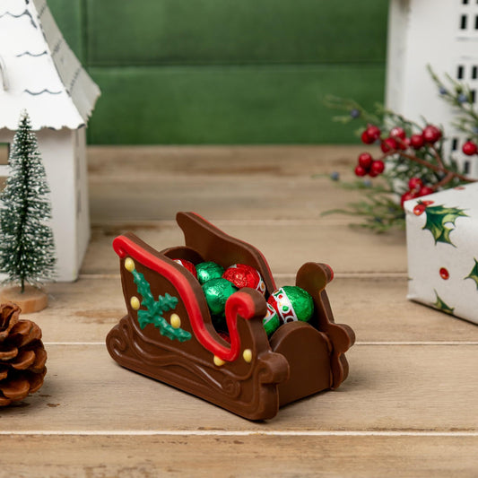 a chocolate sleigh with candy in it