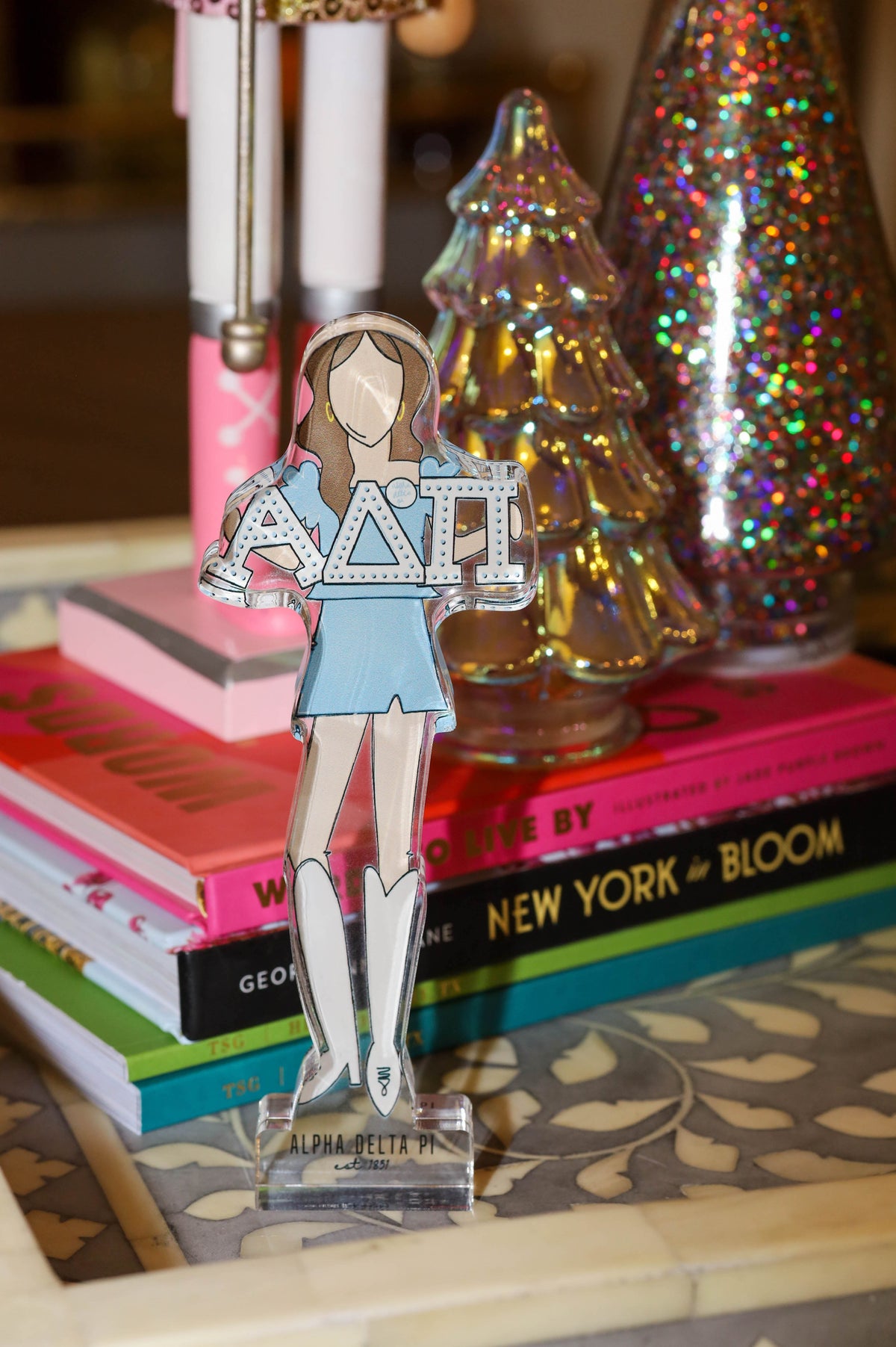 a paper cut out of a girl holding a sign next to books