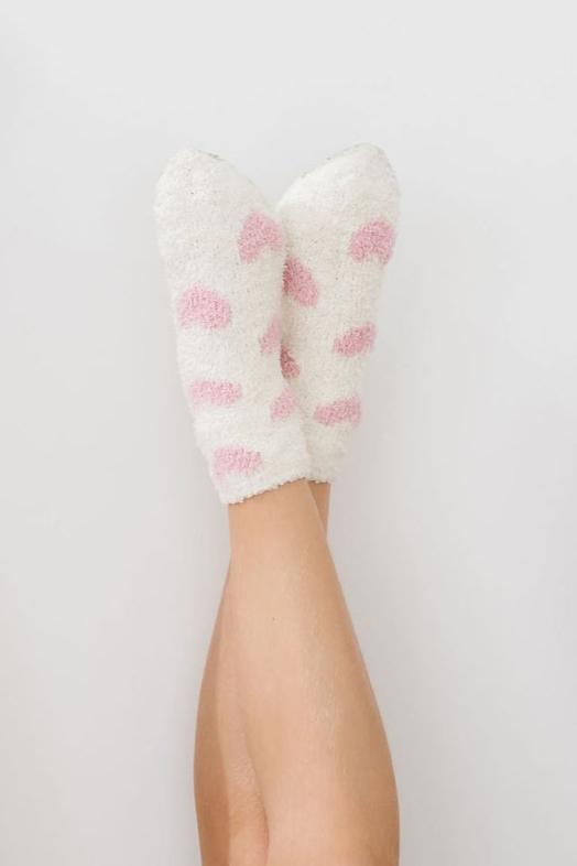 a pair of feet with pink and white socks