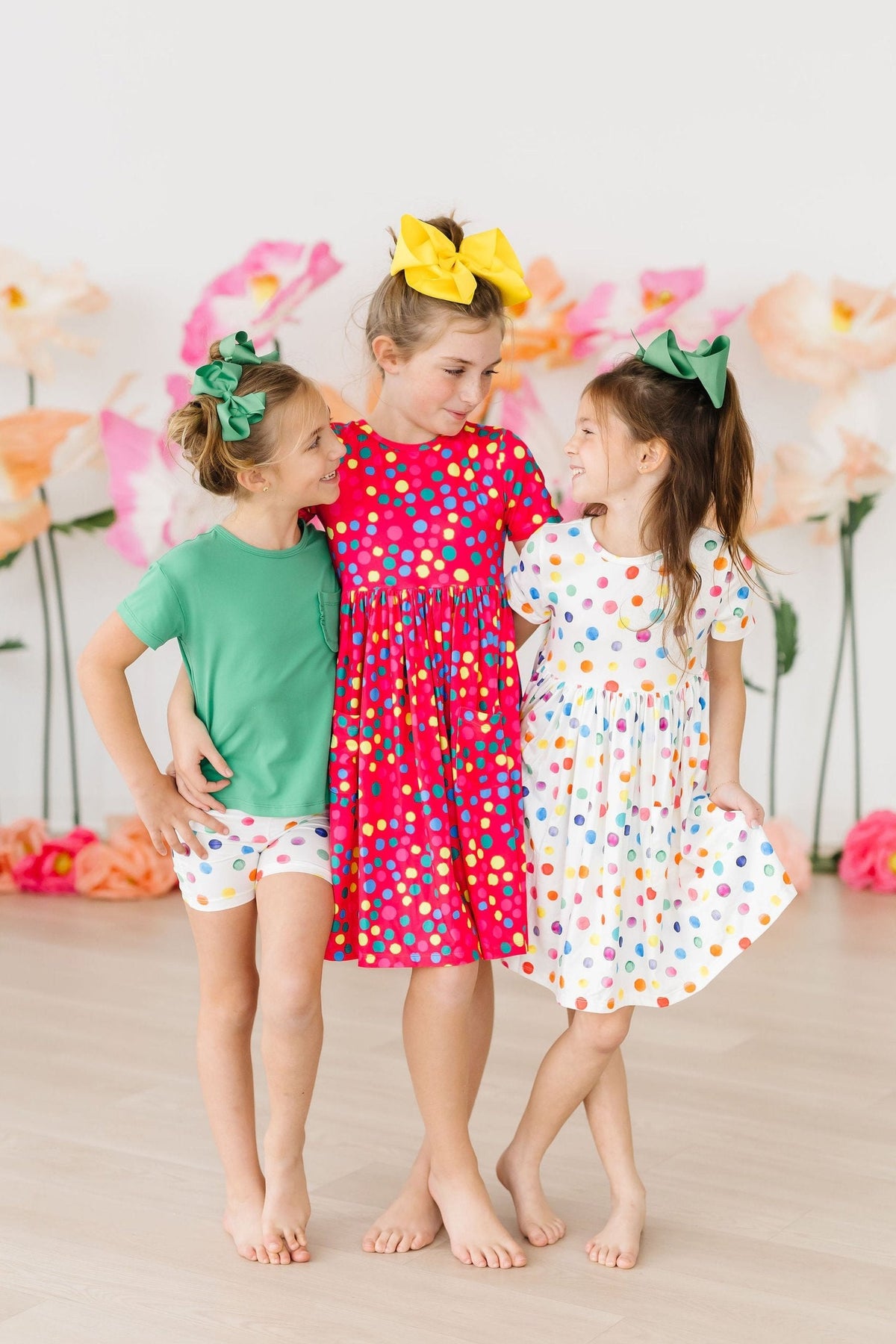 a group of girls in dresses