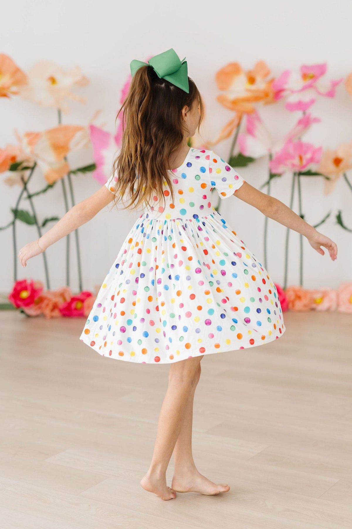 a girl in a polka dot dress