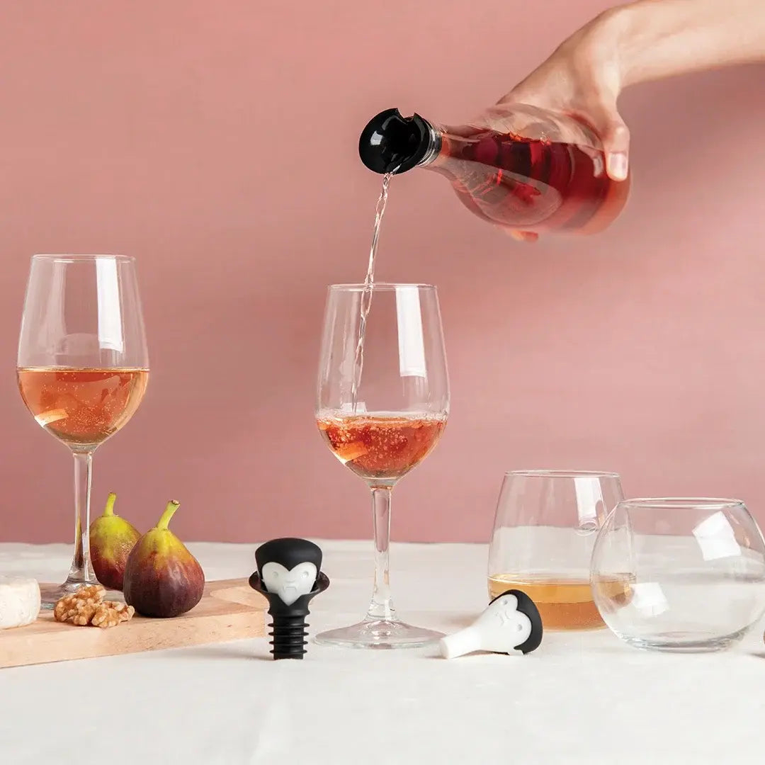 a hand pouring wine into a glass