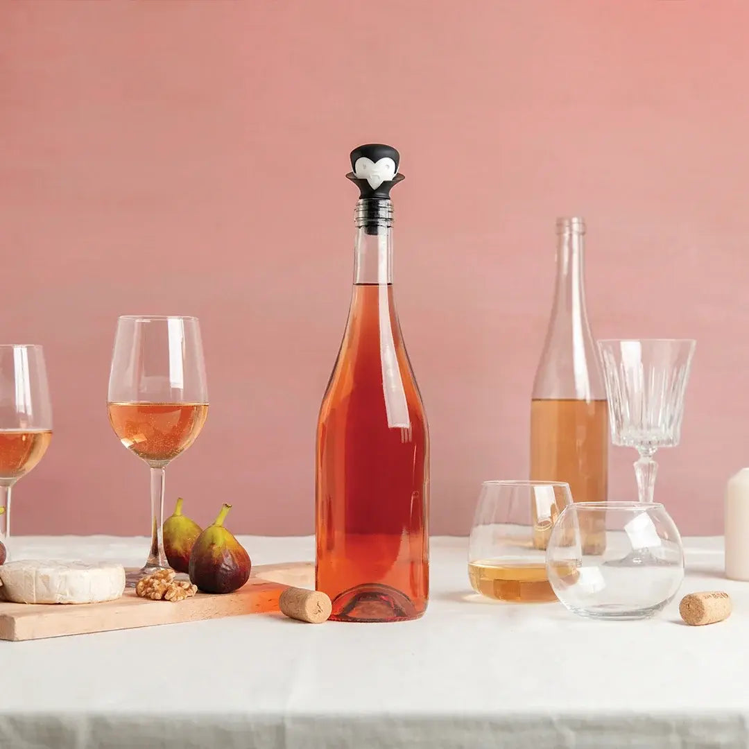 a bottle of wine and glasses on a table