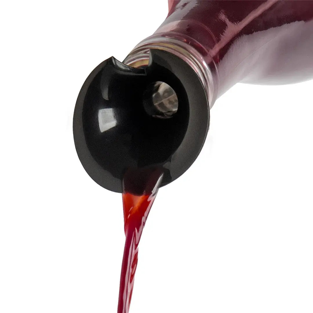 a red liquid pouring from a bottle