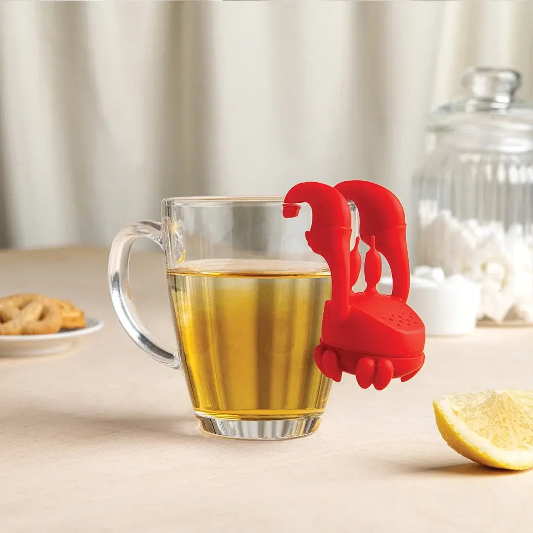 a glass mug with a lobster shaped object on it