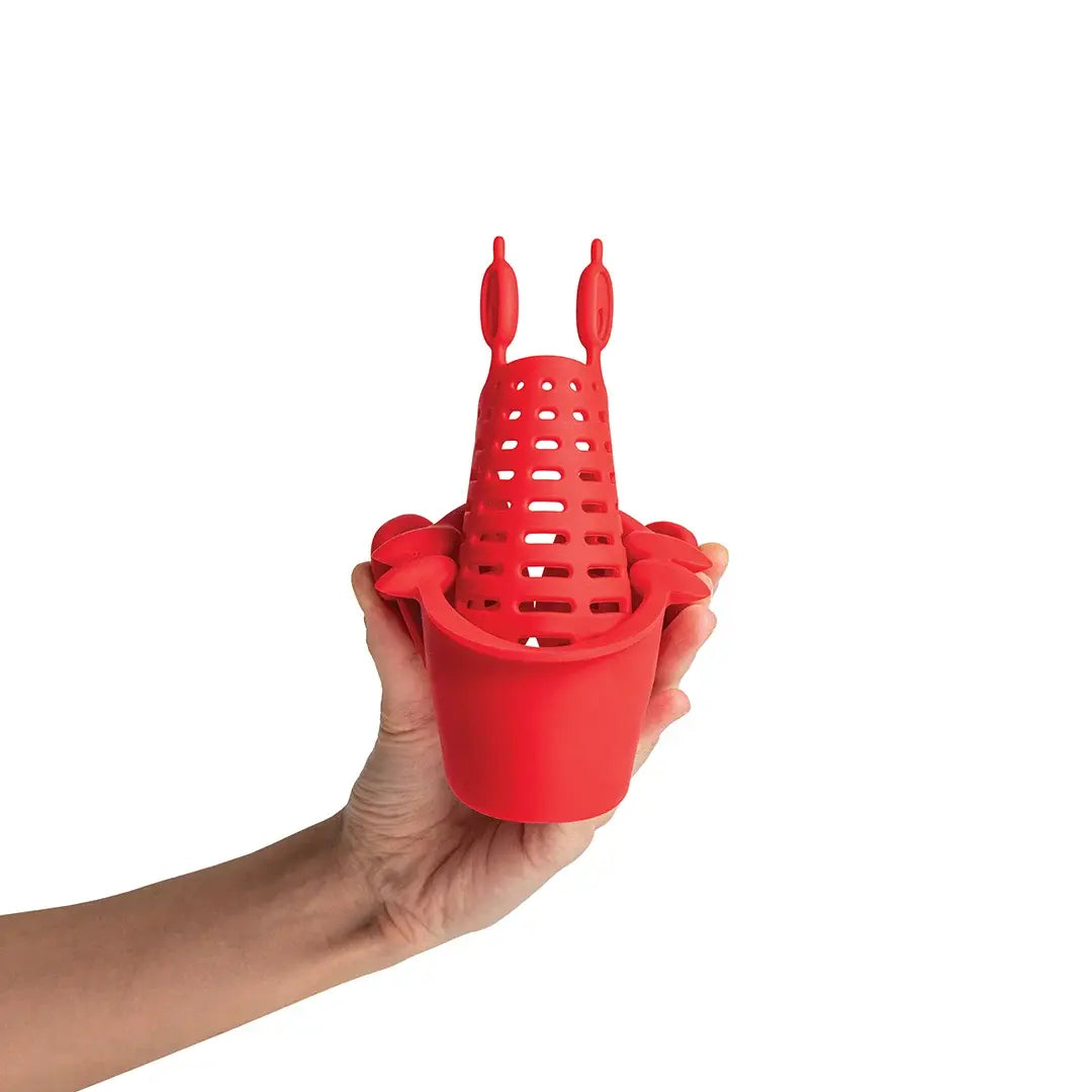 a hand holding a red object